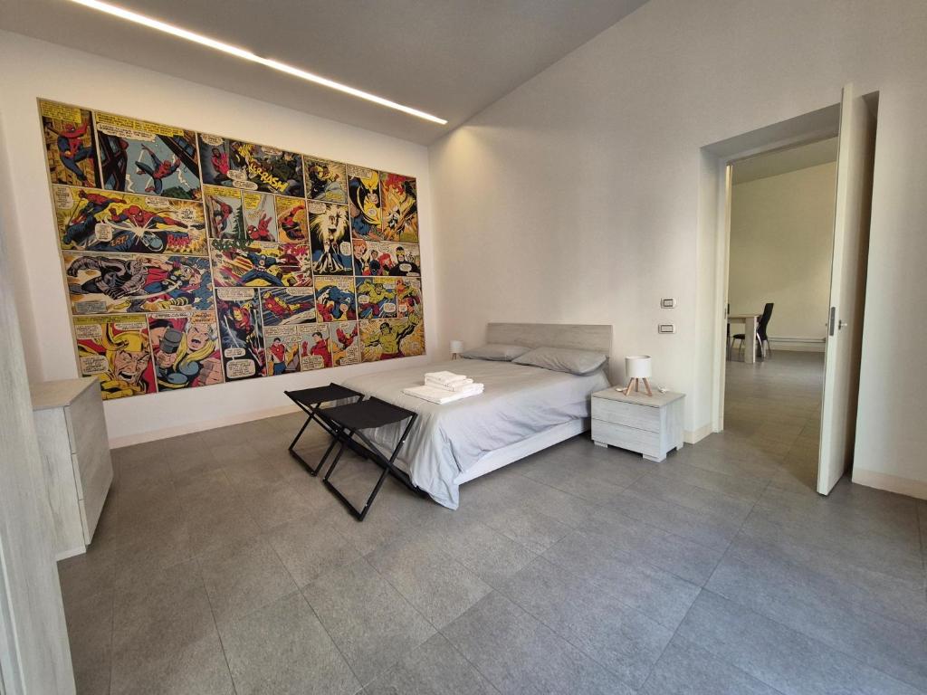 a bedroom with a bed and a large painting on the wall at Casa Bon in Marigliano