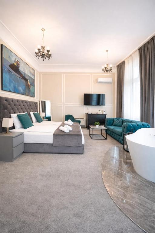 a bedroom with a bed and a living room at Kings Palace Suites in Belgrade