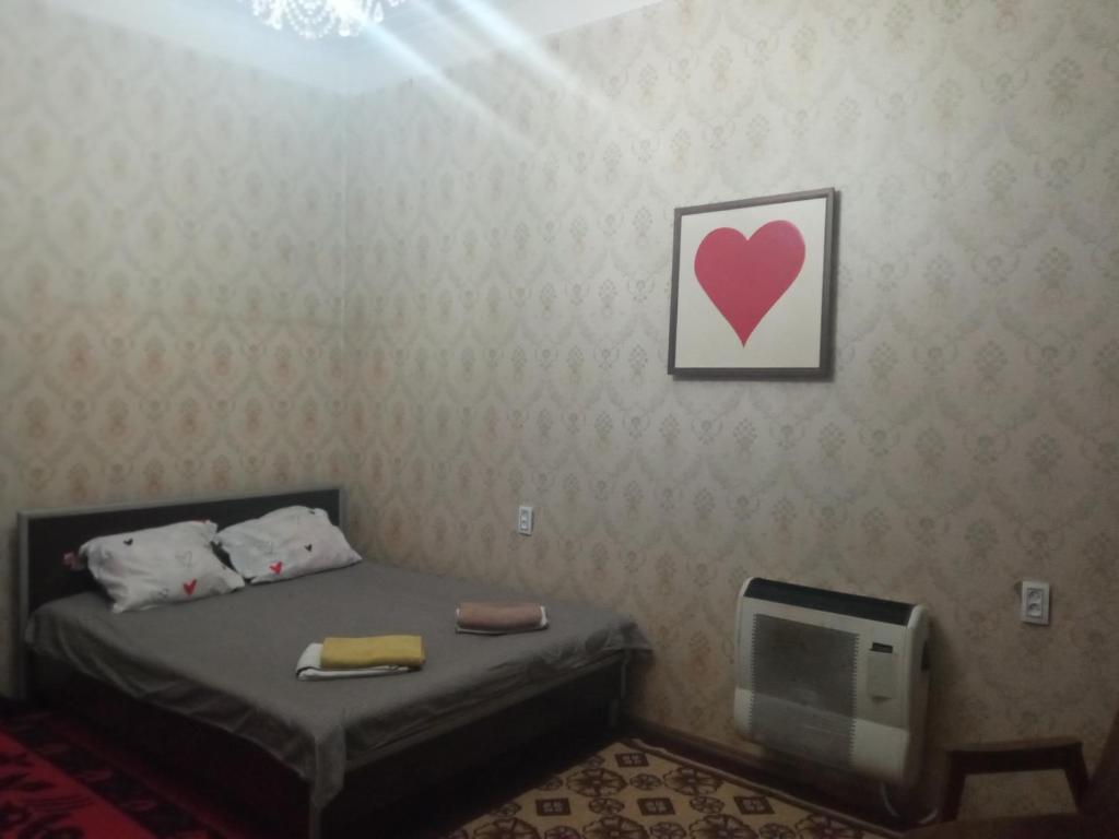 a small bedroom with a bed and a tv at room with a mountain view in Zugdidi