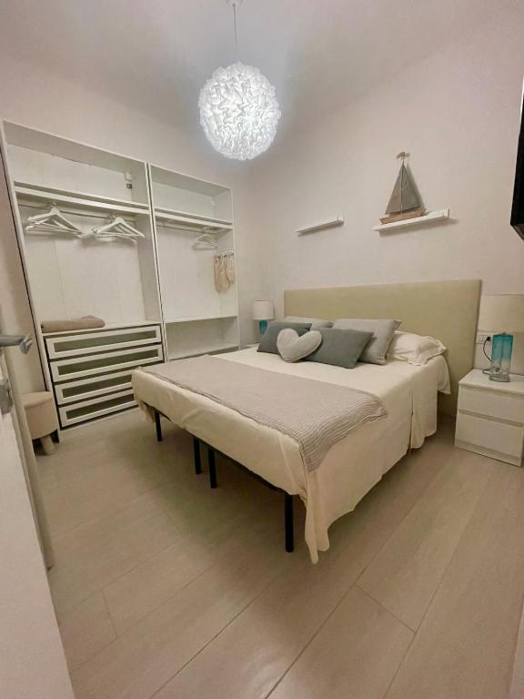 a bedroom with a bed and a chandelier at Stella di Mare with Jacuzzi, Costa Smeralda in Arzachena