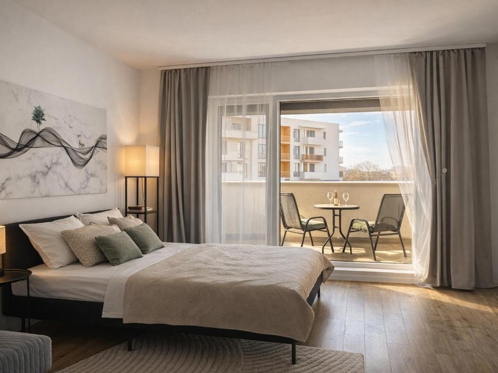 a bedroom with a bed and a balcony with a table at LUMO Terrace Studio with Private Parking near Coresi in Braşov