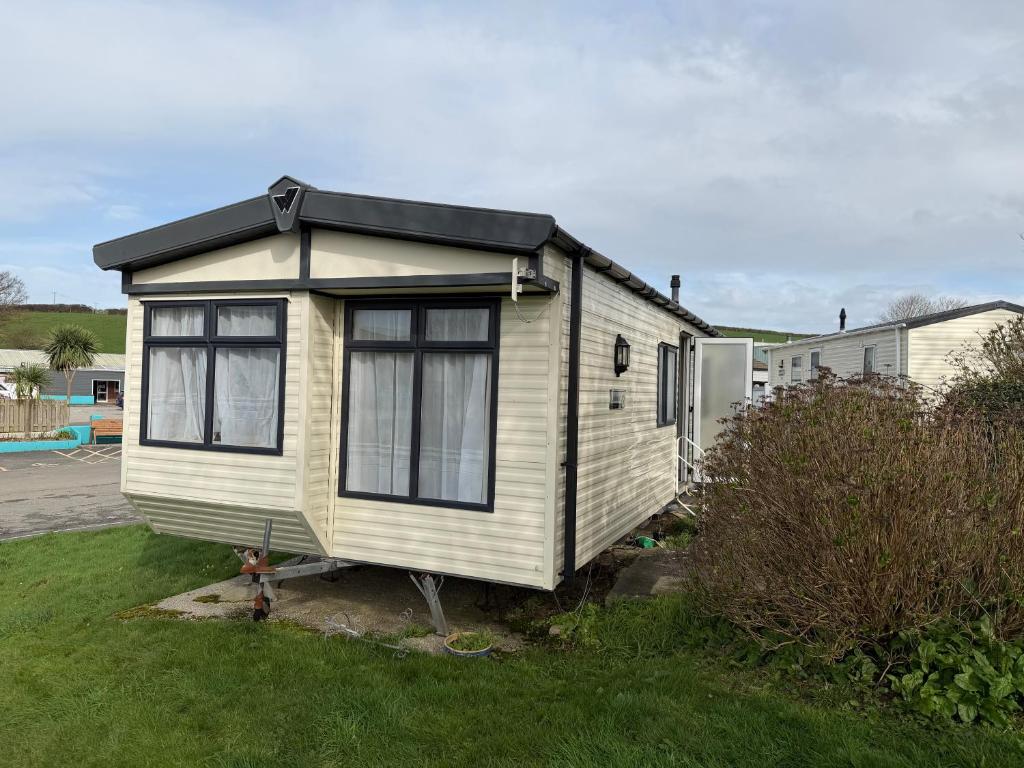 a tiny house is sitting in a yard at Sunshine Newquay Bay Resort in Newquay Bay Resort