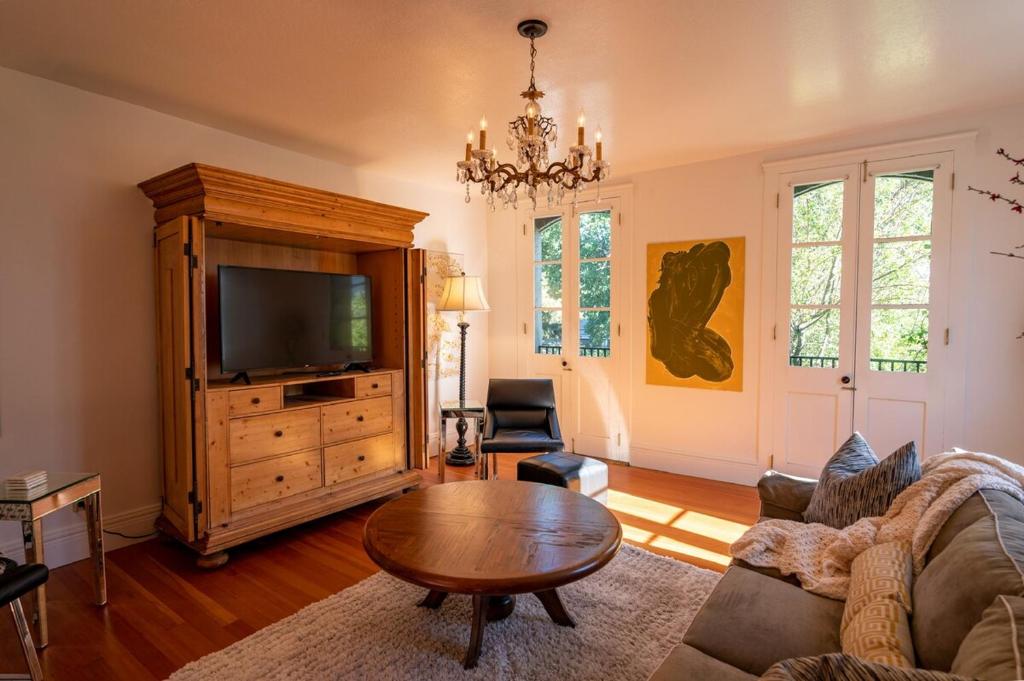 a living room with a couch and a tv at Historic Loft Two 01 in Carson City
