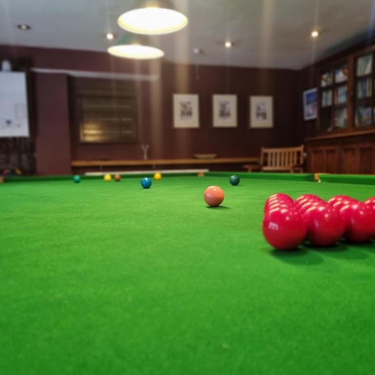 a billiard table with red balls on top of it at Calderbrook House in Hebden Bridge