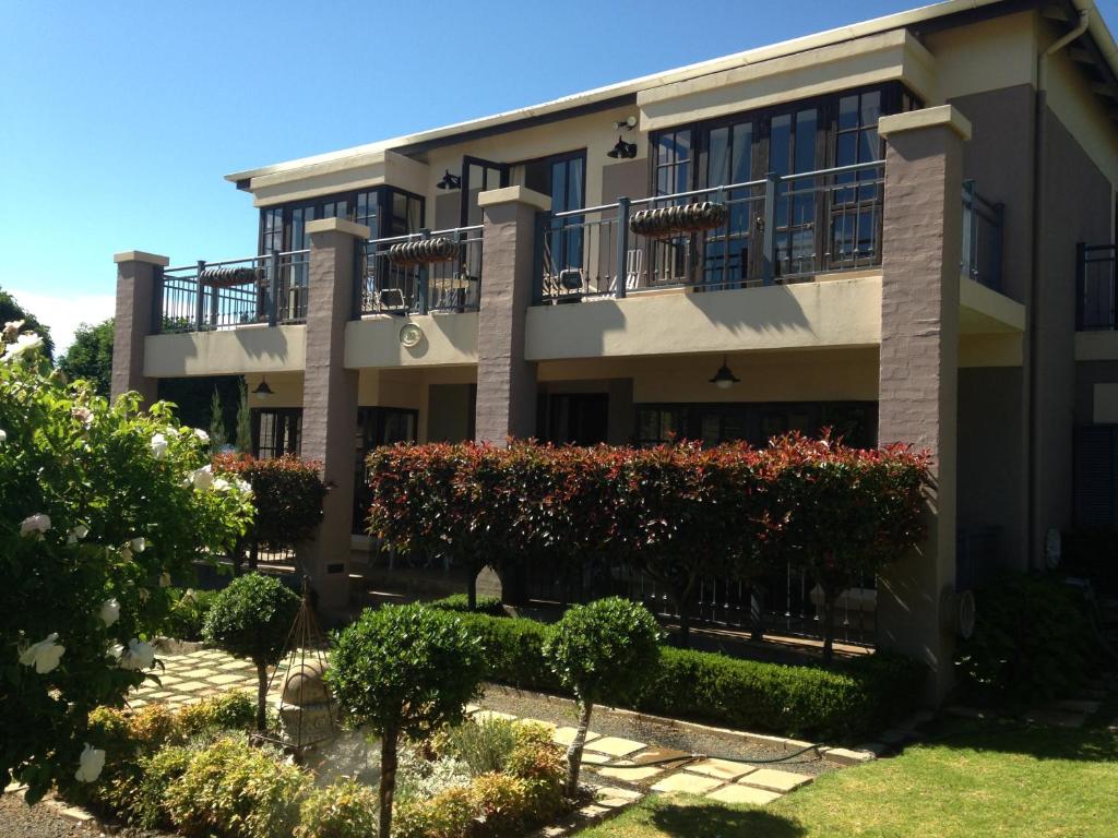an apartment building with bushes in front of it at Periwinkle Blue in Clarens