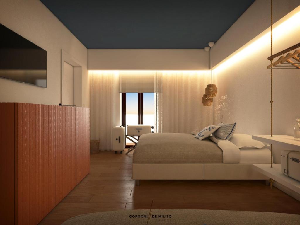 a bedroom with a bed and a room with a window at Vira Verso Est in Otranto