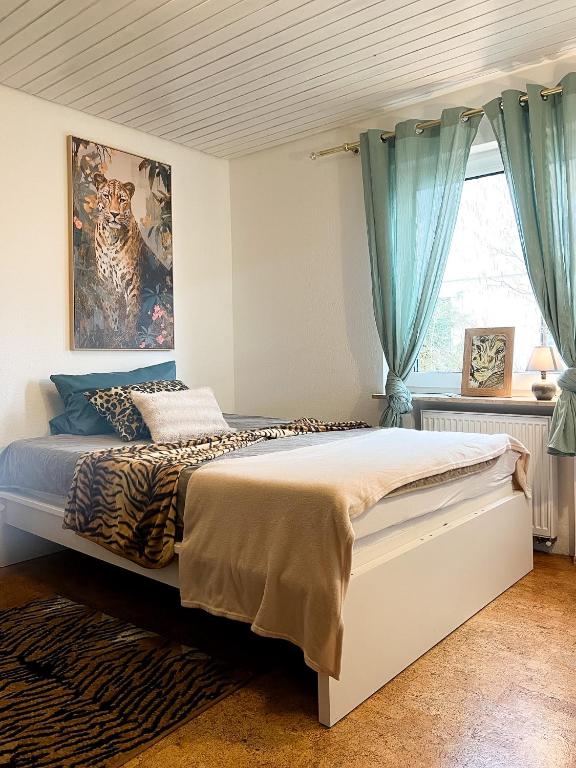 a bedroom with a large bed with blue curtains at Apartments Unterer Kochbuck in Crailsheim