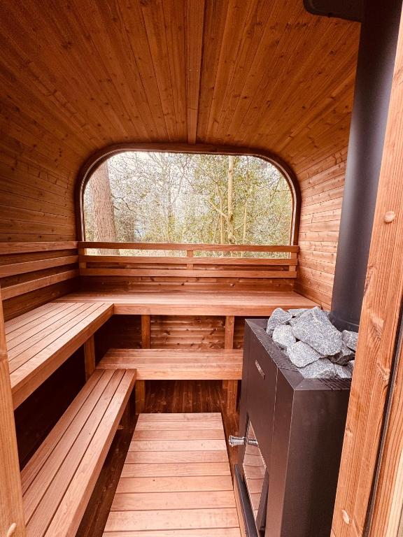 a sauna with a window in a wooden cabin at Dreamers Hut in Dipton