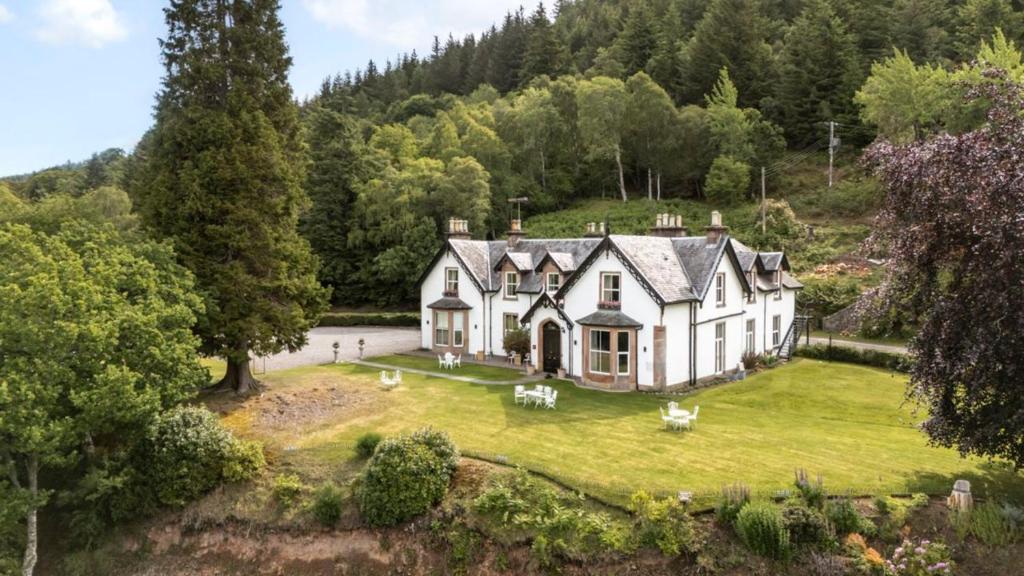 an aerial view of a large white house on a lawn at Foyers Lodge in Foyers