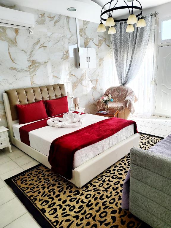 a bedroom with a large bed with red pillows at Sweet Home Suite in Korinthos