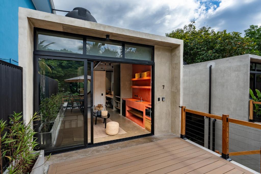 a house with large glass doors on a deck at The Sandhaus - Boutique Design Villa with 8 Suites in Jacó