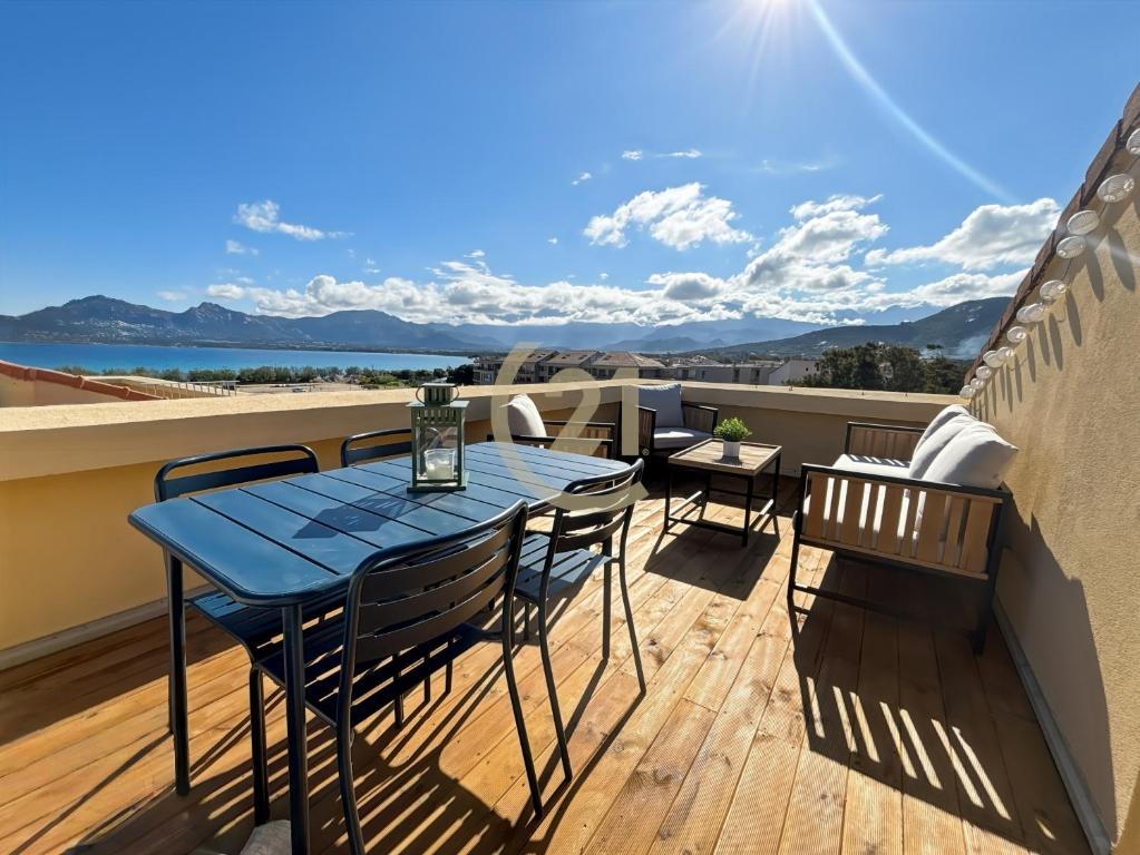 a blue table and chairs on a balcony at Duplex T2 - Madonna di a Sarra in Calvi