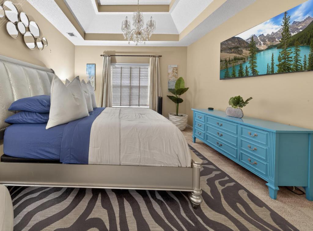 a bedroom with a blue bed and a blue dresser at Master Suite with Private Jacuzzi Tub in McDonough