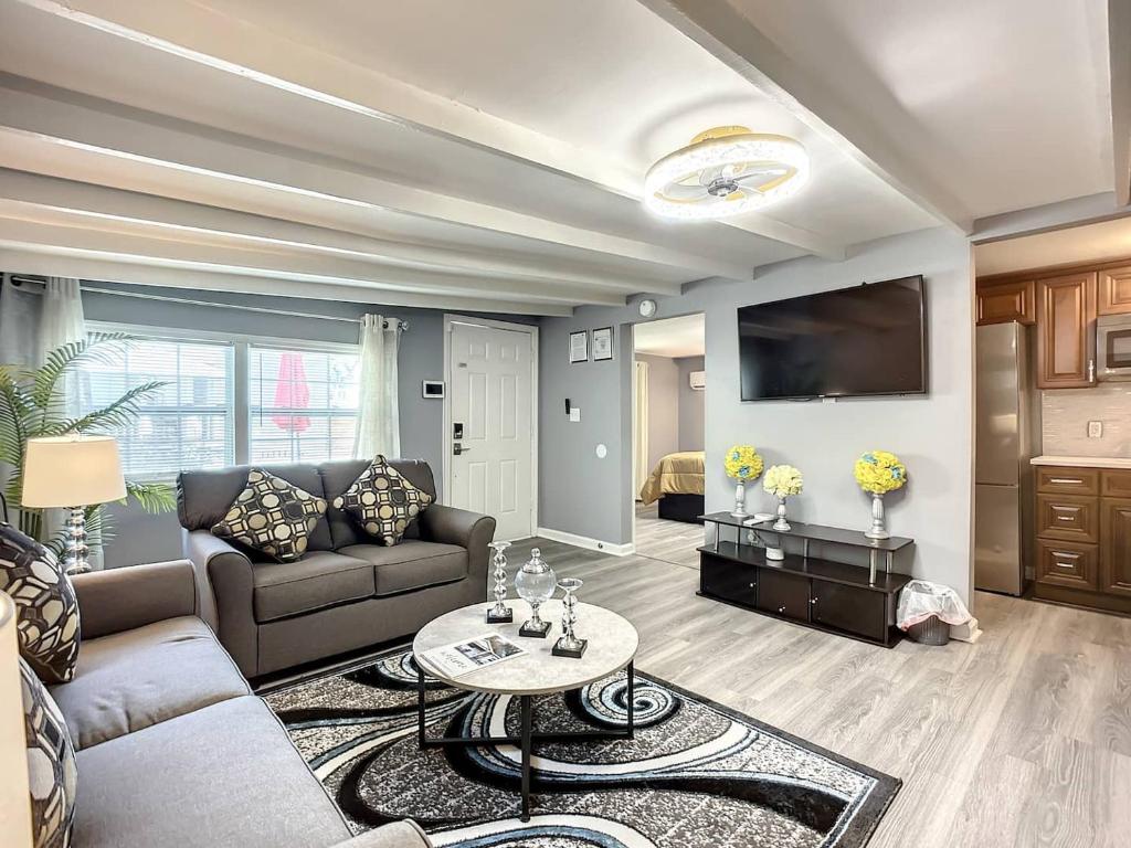 a living room with a couch and a table at Private Guest House 10 Min to Airport & Downtown in Jacksonville