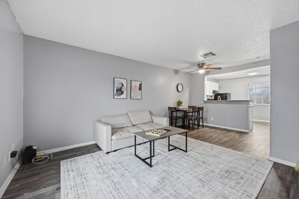 a living room with a couch and a table at Modern 2BR townhome with full kitchen & dining in Arlington