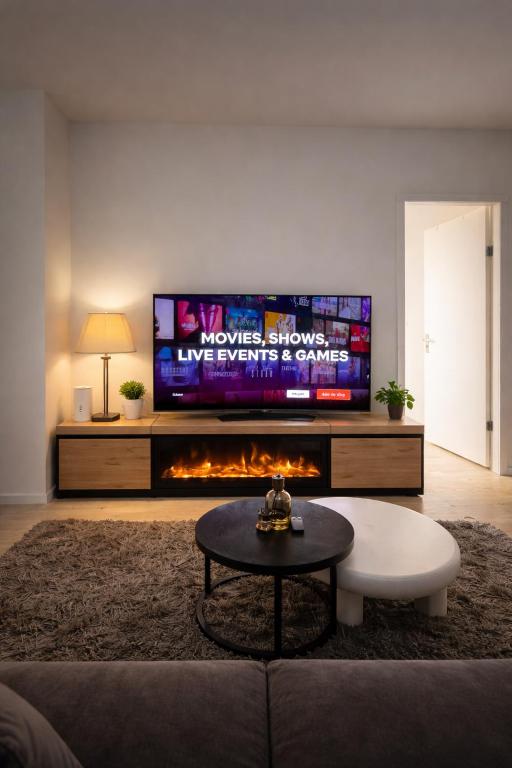 a living room with a tv and a fireplace at Casaejon in Lelystad