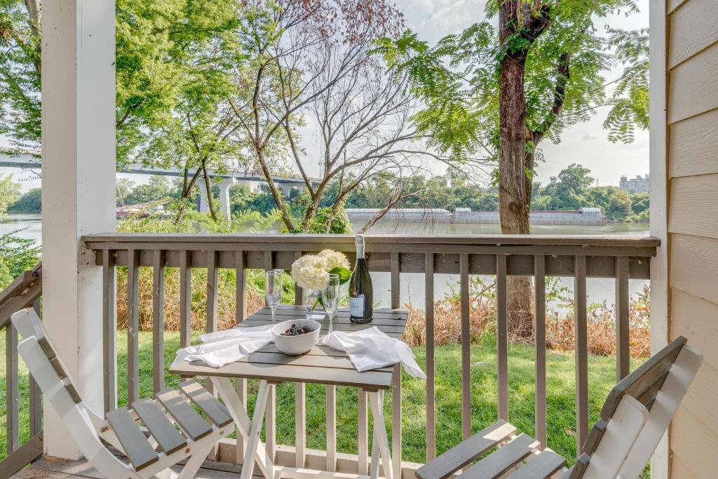 a table and chairs on a porch with a view of the water at Riverfront Retreat-Near Broadway, Pool, Park Free in Nashville