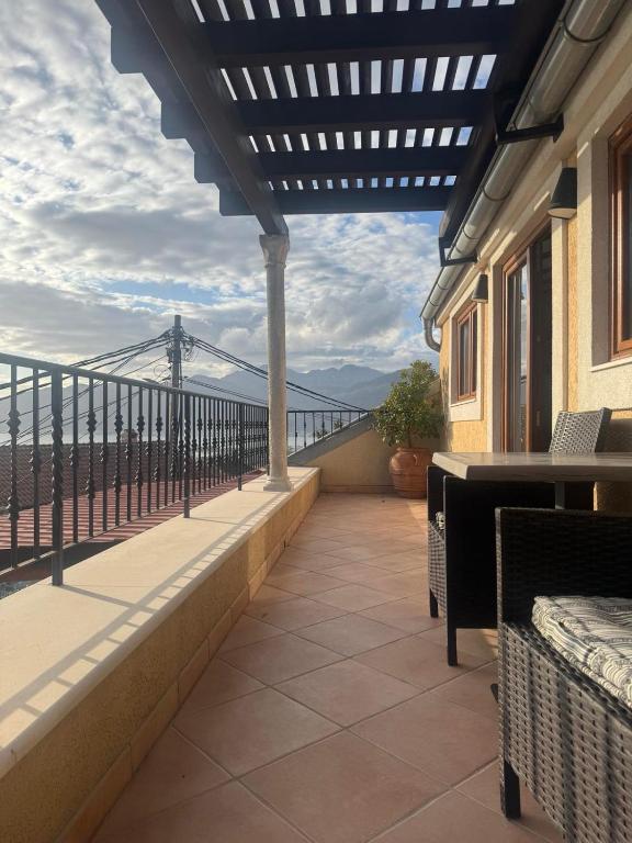 a balcony with a view of the mountains at Seaview Tivat in Tivat