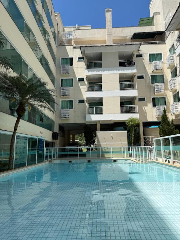 an empty swimming pool in front of a building at 131 - Bombas Summer Beach depto 1 dormitorio para 4 con amenities in Bombinhas