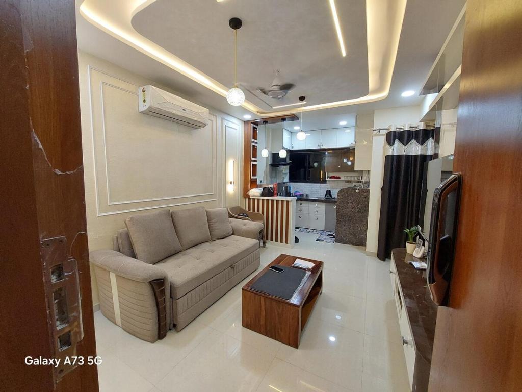 a living room with a couch and a coffee table at The Pinnacle Retreat , Jaitala in Nagpur