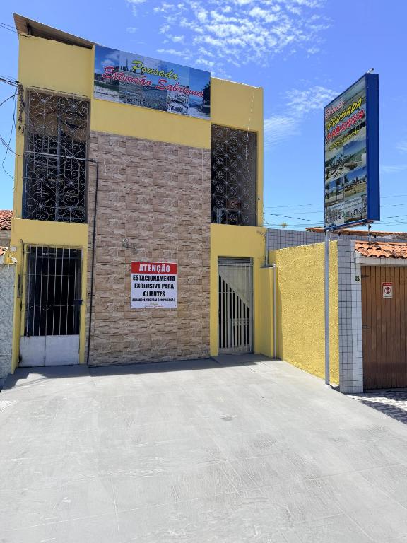 a building with a sign on the side of it at Pousada Extensão Sabrinna in Maceió