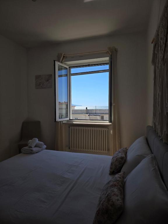 a bedroom with a bed and a large window at Pepe Apartments Asy in Castellammare di Stabia
