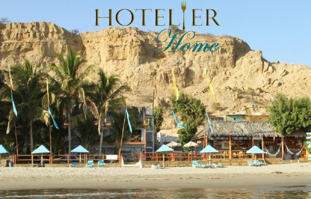 a hotel on the beach in front of a mountain at H0TELIER Home, Máncora in Máncora