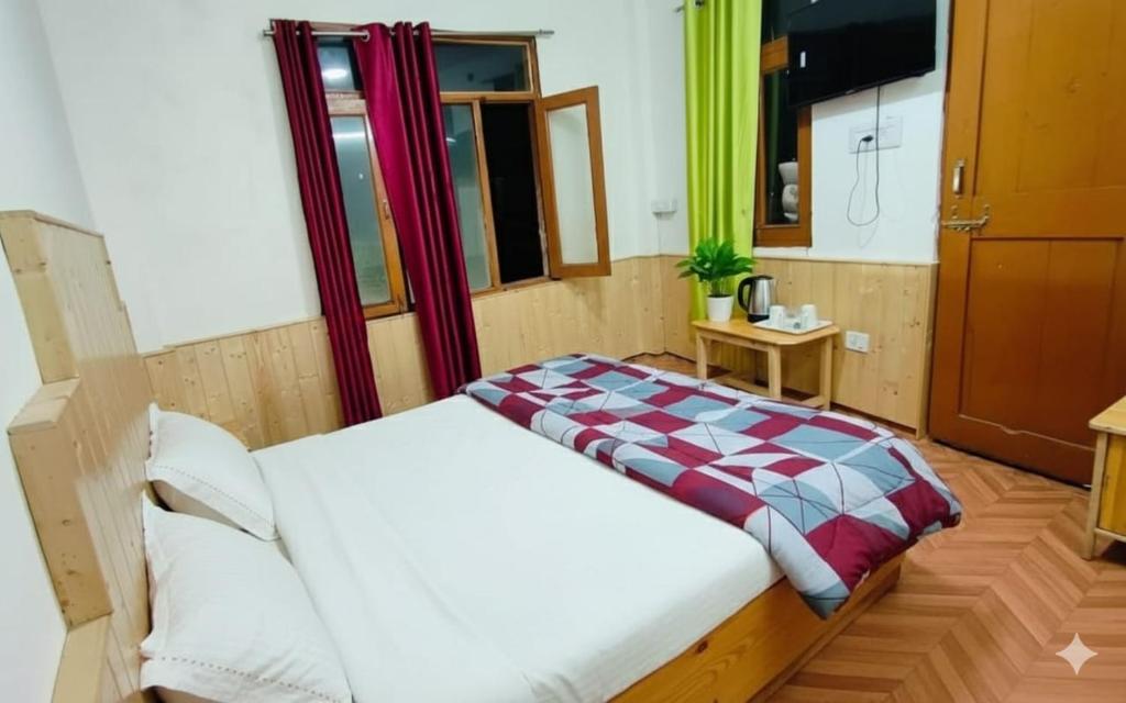 a bedroom with a large bed in a room at CL Villa Manali in Manāli