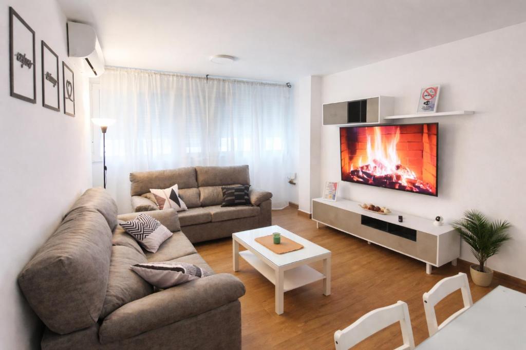 a living room with a couch and a fireplace at CITYHOUSE! NUEVO REFORMADO CONFORT WIFI TV65 AC FULL Visco in San Fernando