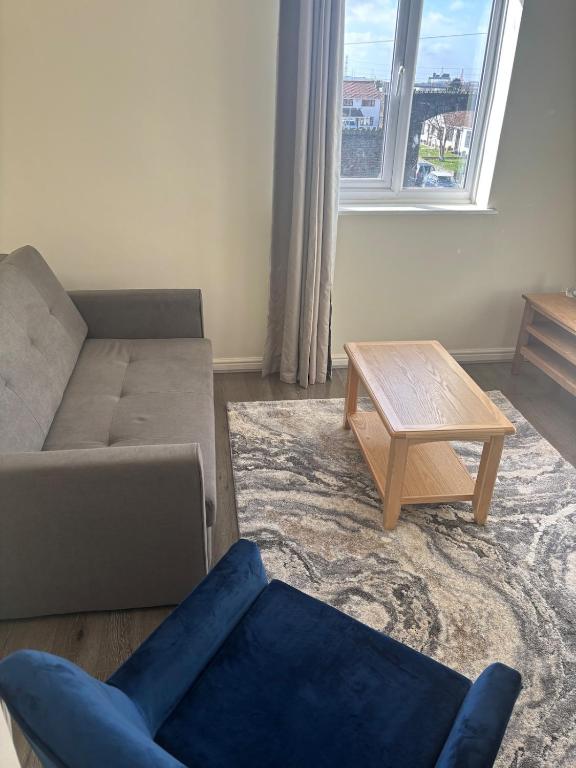 a living room with a couch and a coffee table at Your choice apartment in Shirehampton