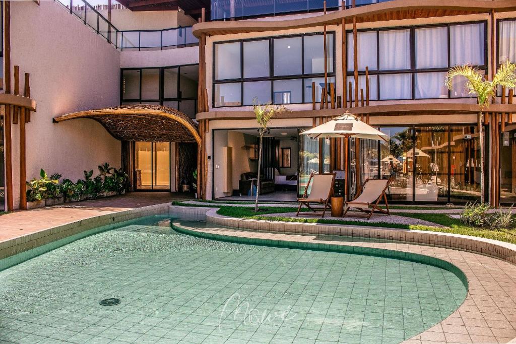 a swimming pool in front of a building at Studio perfeito na Rota de Milagres in Pôrto de Pedras