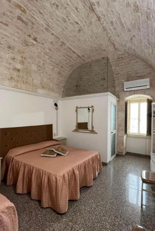 a bedroom with a large bed in a room at Casa Renza in Locorotondo