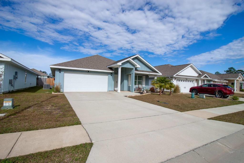 a house with a car parked in a driveway at Off the Grid in Foley