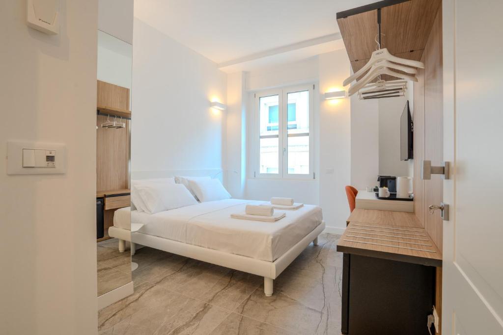 a white bedroom with a bed and a desk at Italianflat - Vandom 2 Duomo Luxury Rooms Foresteria Lombarda in Milan