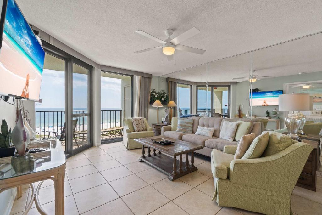 a living room with a couch and a table at Barefoot Getaway in Orange Beach