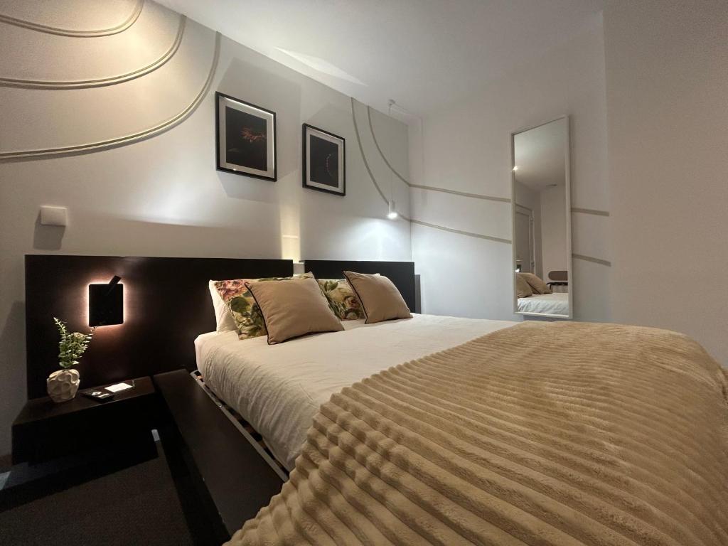 a bedroom with a large bed in a room at Bela vista AL in Paredes de Coura