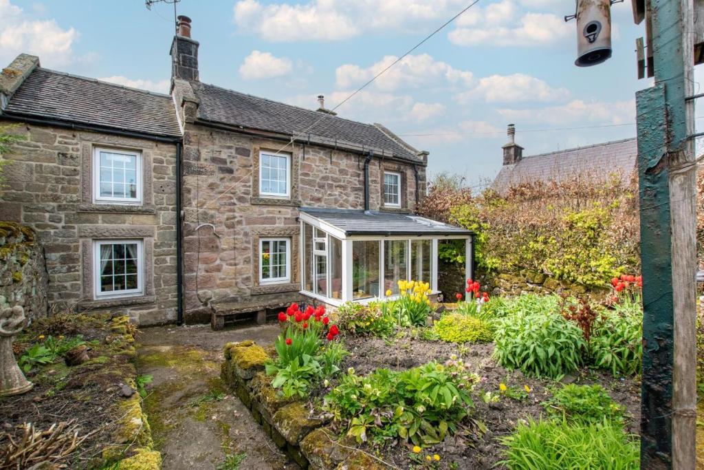 an old stone house with a greenhouse in a garden at 1 Bed in Elton oc-dctco in Elton