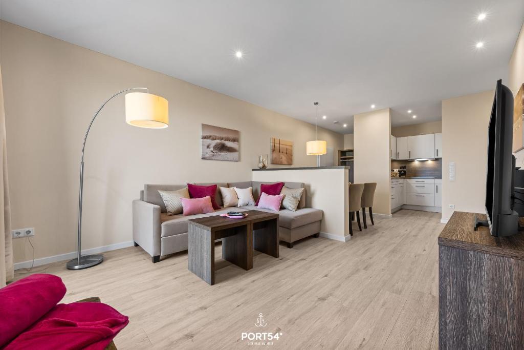 a living room with a couch and a table at Ferienwohnung Lille Hus 3 St Peter-Ording in Böhl