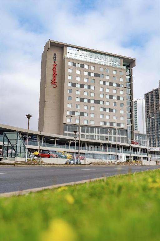 a large building with a sign on the side of it at Hampton By Hilton Antofagasta in Antofagasta
