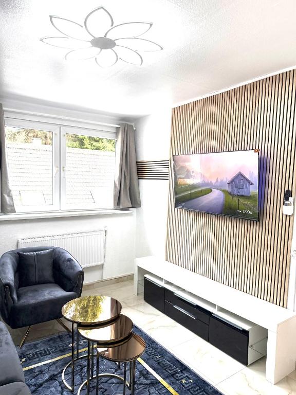 a living room with a couch and a table at MIO Apartments Sulzbach in Schnappach