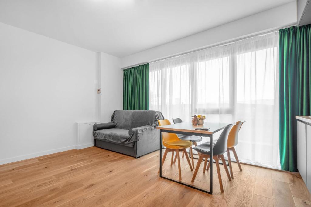 a living room with a table and chairs and a couch at XTN Chill House Aeroport with parking in Cluj-Napoca