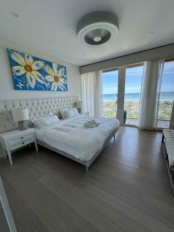 a bedroom with a large bed with a view of the ocean at Oceanfront Oasis in Grange