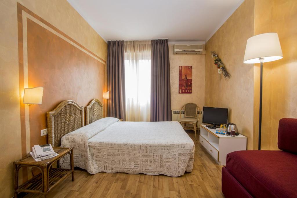 Postel nebo postele na pokoji v ubytování Hotel Le Pageot