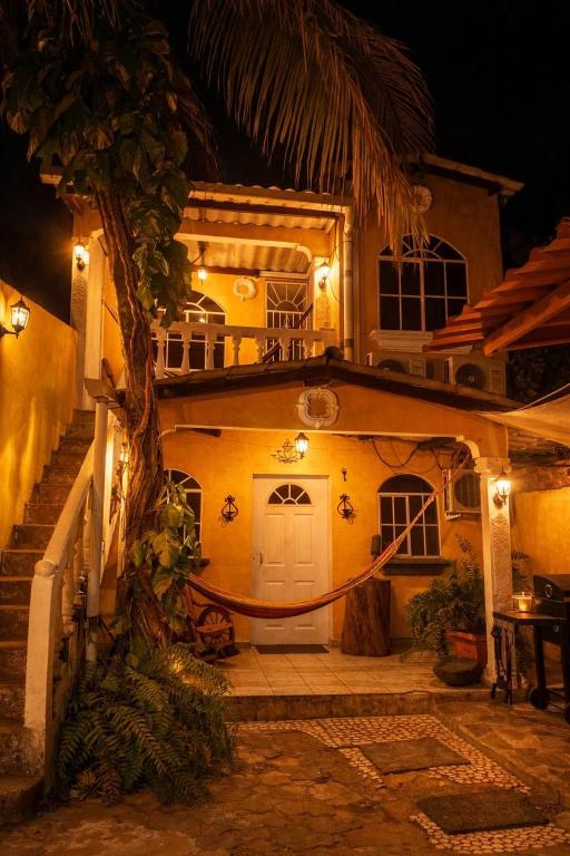 a house with a white door and a porch at night at Hermosa Casa Familiar en Suchitoto in Aguacayo