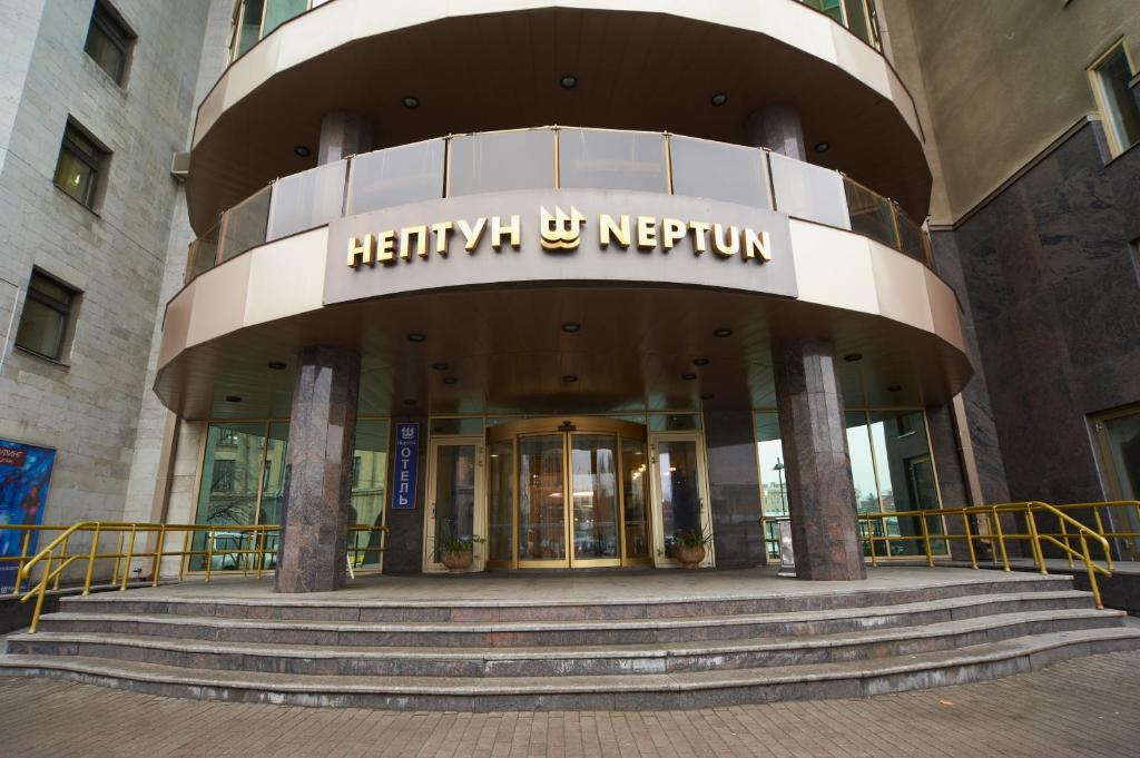 a entrance to a hotel with stairs leading into a building at Neptun Hotel in Saint Petersburg