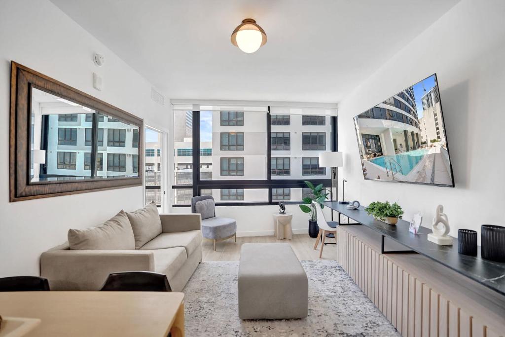 a living room with a couch and a table at Miami Condo 2BR Rooftop Pool & Gym in Miami