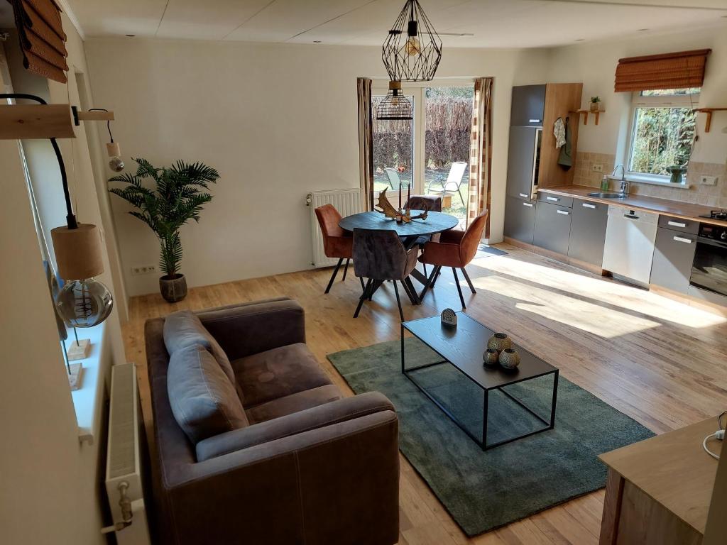 a living room with a couch and a table at Het Gewei in Burgh Haamstede