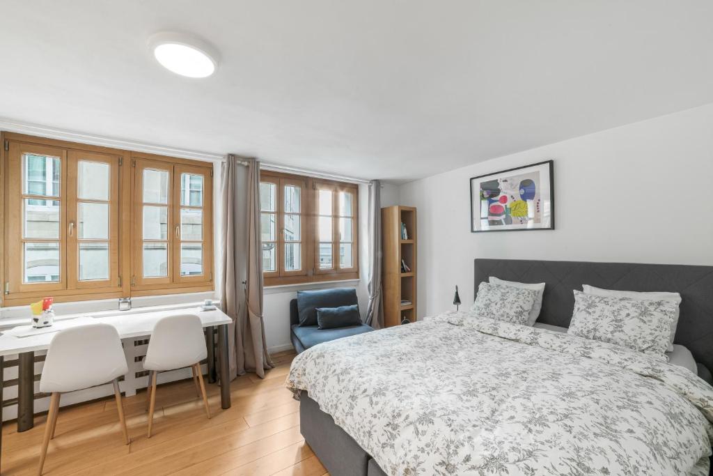 a bedroom with a bed and a table and chairs at Boël 3 studio in Geneva
