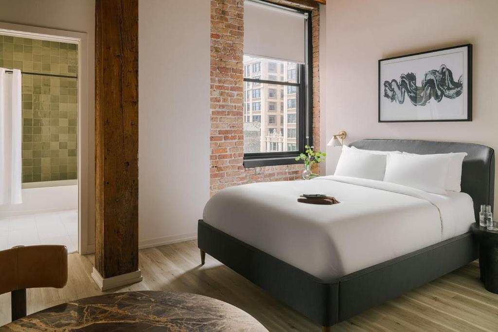 a bedroom with a large white bed and a window at LIVN West Loop Chicago Queen Superior Studio in Chicago