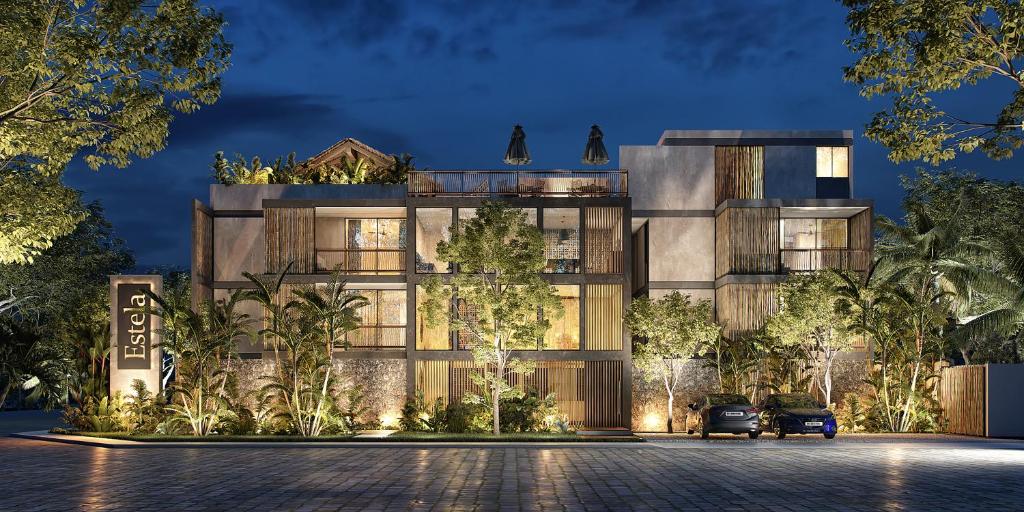 a rendering of a building at night at Premium Apartment in Tulum 2 Bedrooms Roof Top Pool - Aldea Zama in Tulum